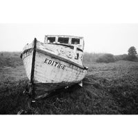 Old wooden boat named 'Edith-E' in a grassy field