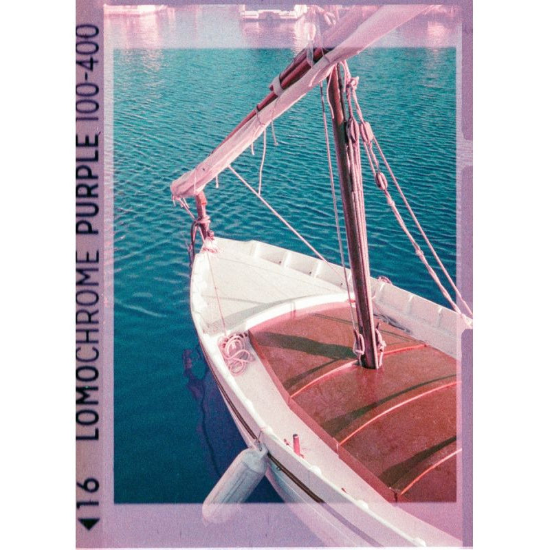 Sailboat on water with Lomochrome Purple 100-400 film effect overlay