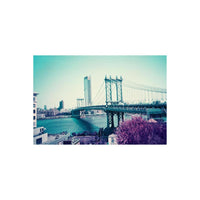 Manhattan Bridge view shot on LomoChrome Purple 110 film with surreal purple foliage and teal-toned water.