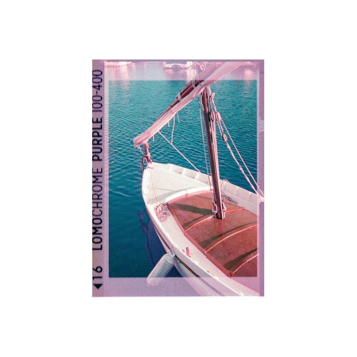 Sailboat on water with Lomochrome Purple 100-400 film effect overlay