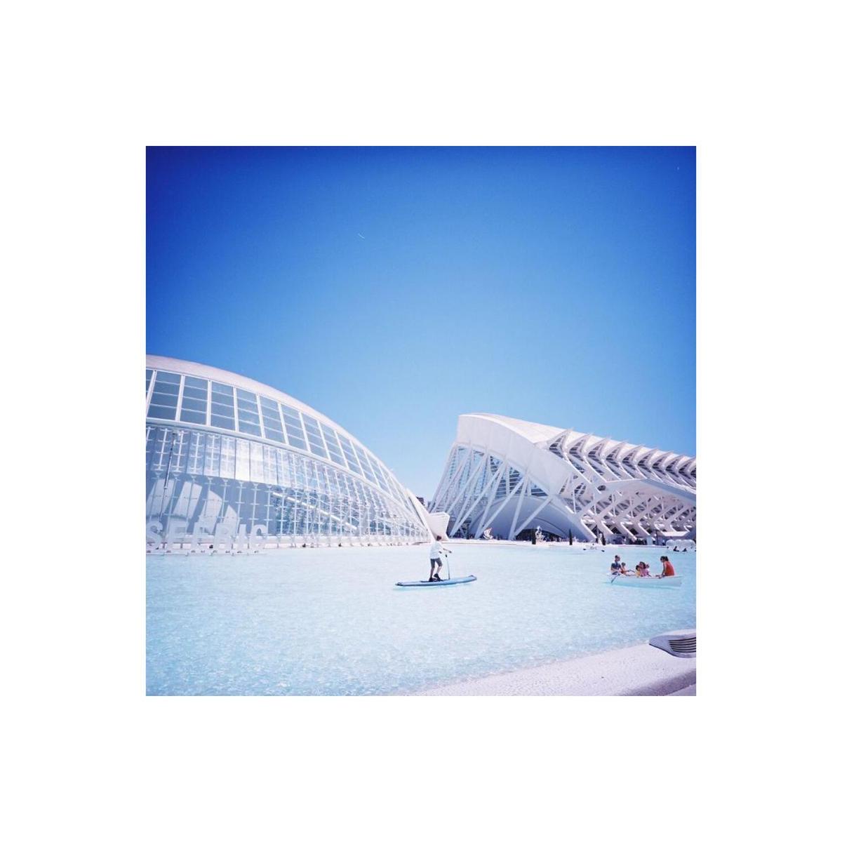 Vibrant daylight shot of modern white architecture and a bright blue pool, captured on Lomography 100 120 film.