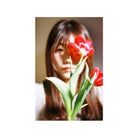 Portrait of a person holding a vibrant red tulip in front of their face, captured on 35mm color negative film.