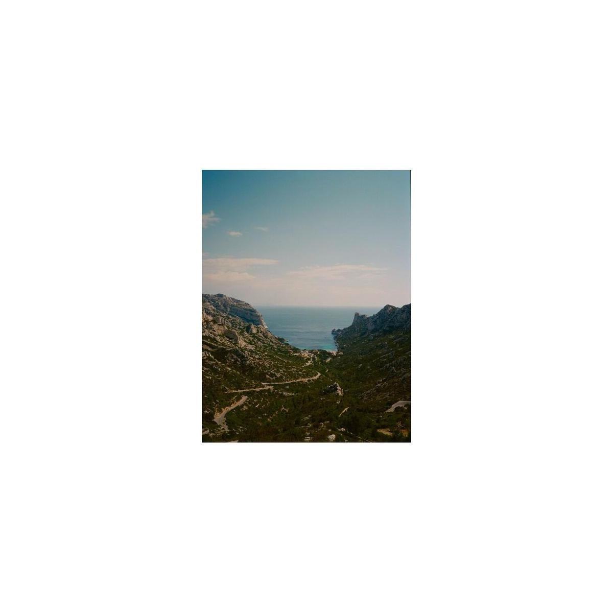 Vibrant landscape shot of a coastal valley leading to the sea, captured on Lomography 400 ISO 120 color negative film.