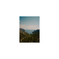 Vibrant landscape shot of a coastal valley leading to the sea, captured on Lomography 400 ISO 120 color negative film.