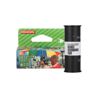 Lomography 800 ISO 120 color negative film roll and its green branded cardboard packaging box.