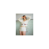 A person wearing a white floral cardigan and knit shorts, captured with the bold, grainy aesthetic of Lomography 800 film.