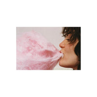 Profile view of a person eating bright pink cotton candy, captured with the saturated, grainy aesthetic of Lomography 800 film.