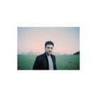Portrait of a man in a black coat standing in a field at dusk, captured with Lomography 800 ISO 35mm color film.