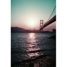 Golden Gate Bridge at sunset with vintage purple and teal color shifts captured on 35mm film.