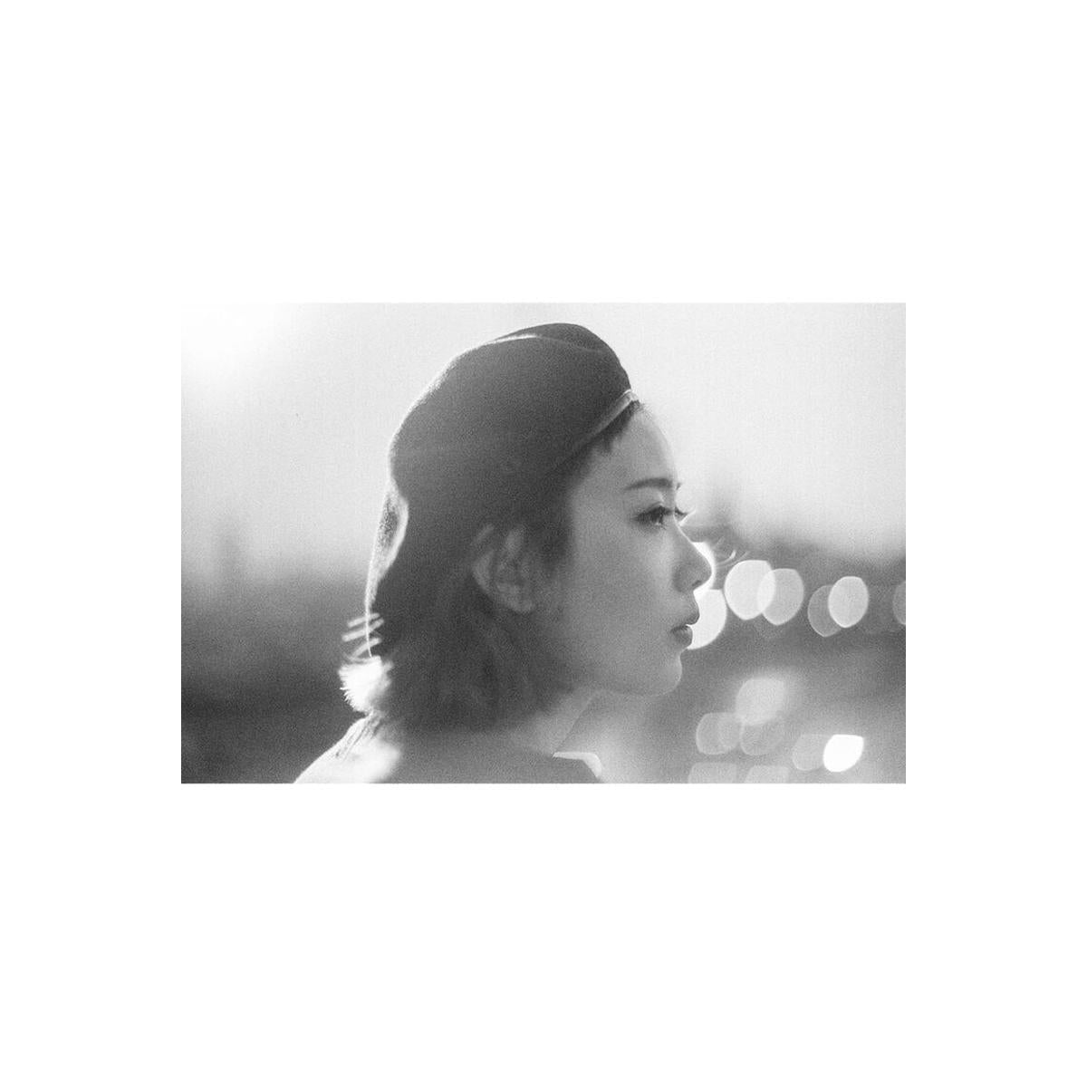 Black and white portrait of a woman in a beret, captured with high-contrast, fine-grain 35mm film style.