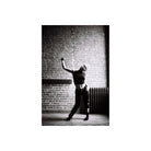 High-contrast black and white portrait of a person posing against a brick wall, shot on Lomography Earl Grey 100 film.
