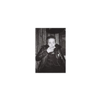 High-contrast black and white portrait of a man in a leather jacket holding a cocktail, shot on Lomography Earl Grey film.