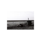 High-contrast black and white beach scene with a lifeguard tower and truck, captured on Lomography Fantome Kino 8 film.