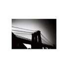 High-contrast black and white photograph of the Brooklyn Bridge silhouette against a bright sky, shot on 35mm film.