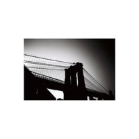 High-contrast black and white photograph of the Brooklyn Bridge silhouette against a bright sky, shot on 35mm film.