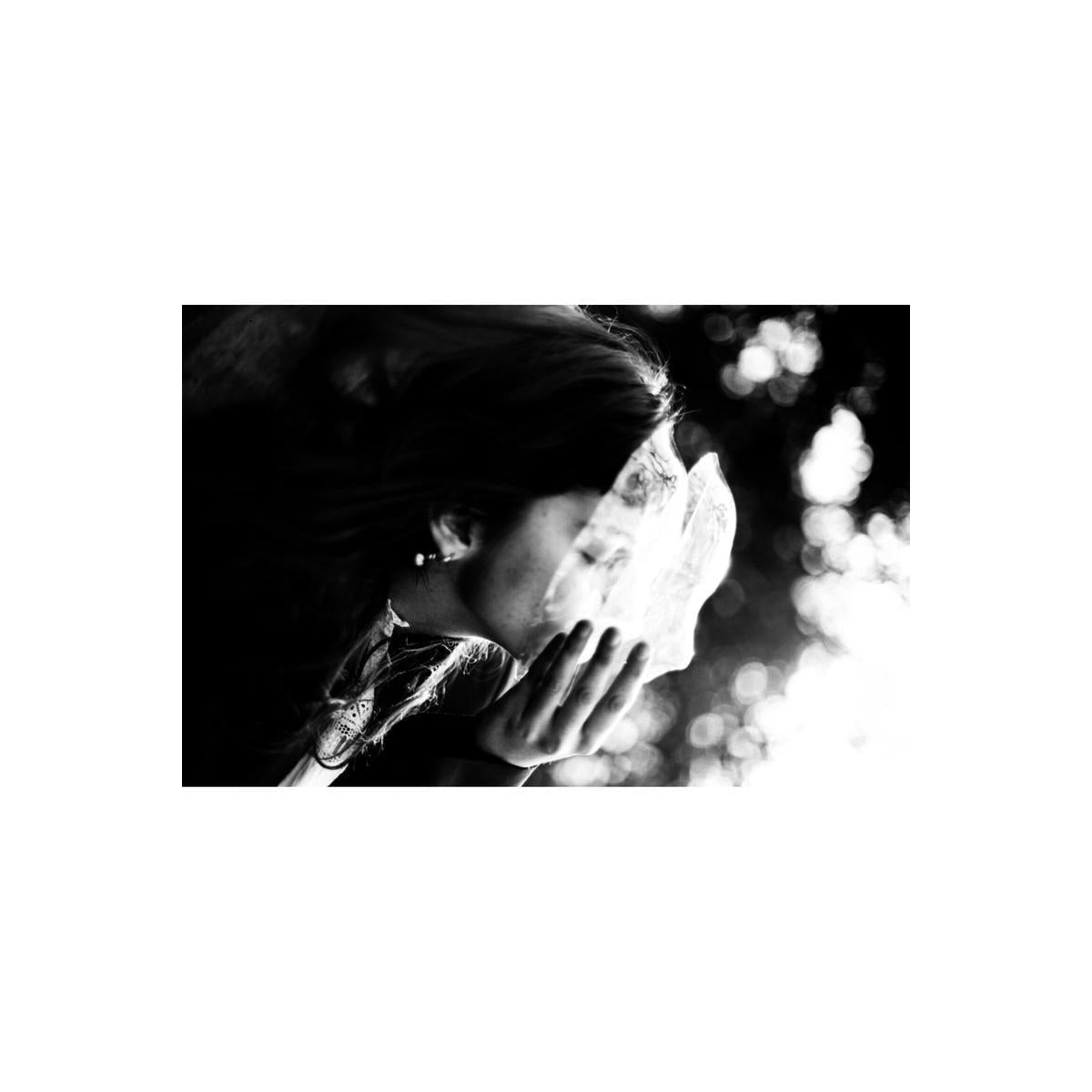 High-contrast black and white portrait shot on Lomography Fantome Kino 8 film, featuring deep shadows and fine grain.