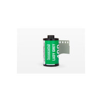 Lomography Lady Grey 400 35mm black and white film roll with a bright green label and exposed film leader.