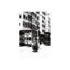 Black and white street scene featuring a person pushing a cart between two double-decker trams in a city.