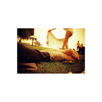 Tattooed legs resting on grass in a warm, red-toned scene captured with Lomography Redscale 35mm film.