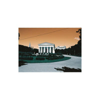 Neoclassical building in a park with turquoise foliage and a gold-toned sky, captured on LomoChrome Turquoise 35mm film.