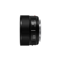 The side of a black camera lens on a white background