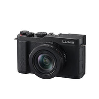 Black camera  at an angle with the word Lumix on it set on a white background