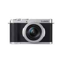 Silver and black camera with the logo name of Lumix on the front on a background