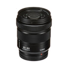 Panasonic Lumix 20-60mm f/4-5.6mm lens in black with white text markings and a small red indicator dot, shown on a white background.