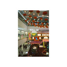 A vertical art print depicting a bustling indoor shopping mall atrium with red lanterns hanging from the ceiling, bright storefronts, and people walking below, framed by a wide white border.