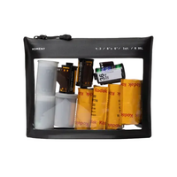 A black reusable travel film pouch with a clear window displaying various film rolls and a label with 'Moment' branding on the top.