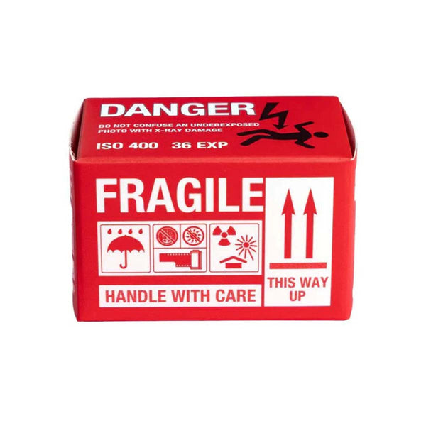 A red and white shipping box with handling instructions, including 'DANGER', 'FRAGILE', 'HANDLE WITH CARE', and 'THIS WAY UP' printed in white and black.