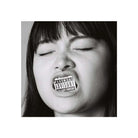 A black and white square portrait of a person with eyes closed, holding a parental advisory label over their mouth, centered on a white background.