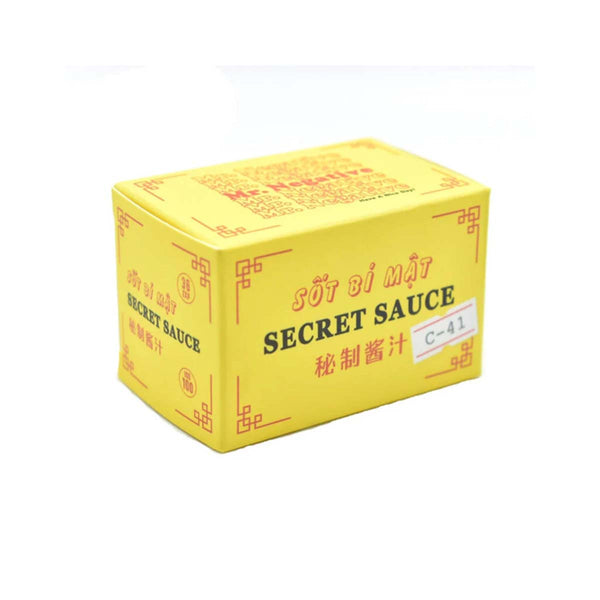 A yellow rectangular box of Secret Sauce, featuring red decorative borders and text in English and Chinese, set against a plain white background.