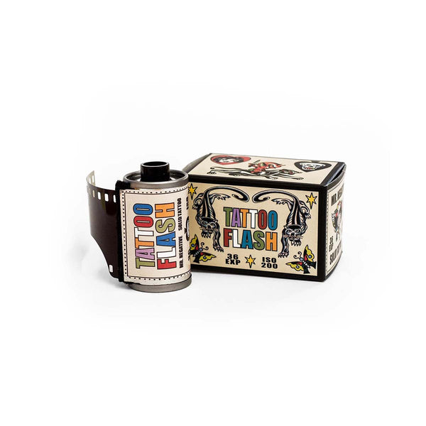 A roll of vintage-style tattoo flash film next to its illustrated cardboard box on a clean white background.