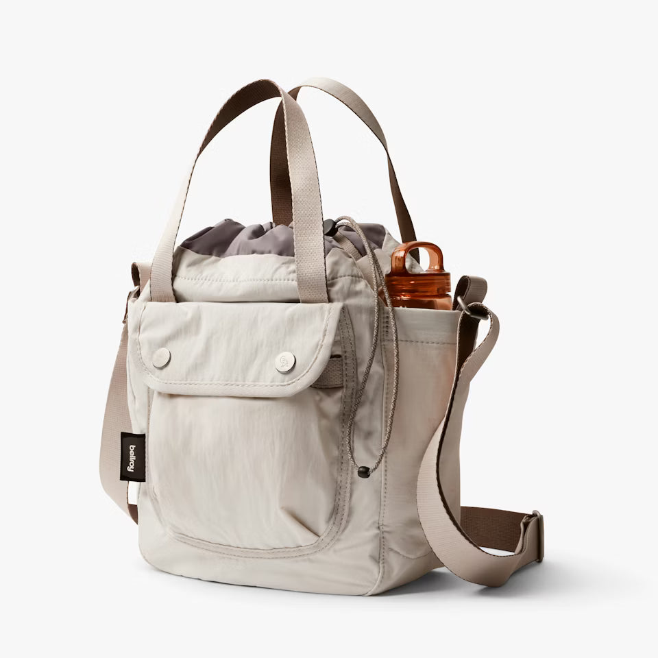 Beige backpack with a shoulder strap on a white background