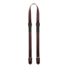 Brown suspenders with black clips on a white background