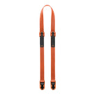 Orange strap with black buckles on a white background