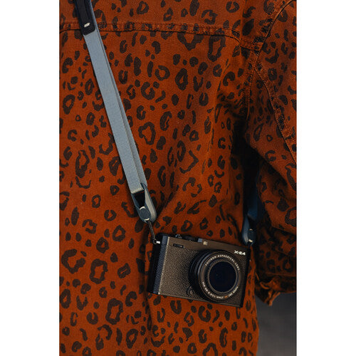 Camera with strap over a leopard print jacket