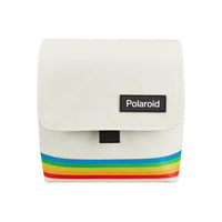 White nylon Polaroid box camera bag featuring a rainbow stripe design, fold-over flap, and black Polaroid logo patch.