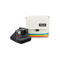 White nylon Polaroid box camera bag with a rainbow stripe and a black camera on a white background.