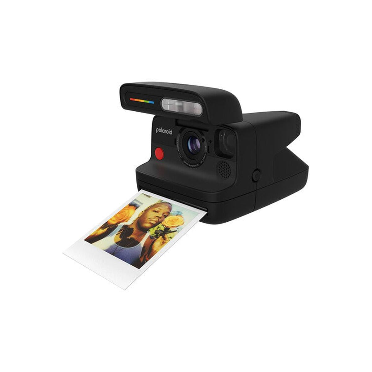 Matte black Polaroid instant camera ejecting a square film print with a portrait of a person holding yellow roses.
