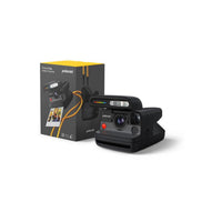 Black Polaroid Flip instant camera with a retractable lens cover and yellow wrist strap next to its product box.