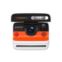 Polaroid Flip instant camera in white and orange with a retractable cover, sonar autofocus lens, and built-in flash.