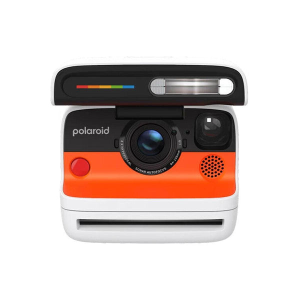 Polaroid Flip instant camera in white and orange with a retractable cover, sonar autofocus lens, and built-in flash.