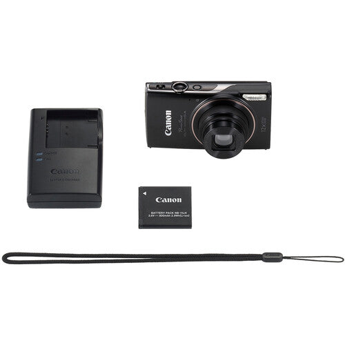 Canon camera with battery, charger, and strap on a white background