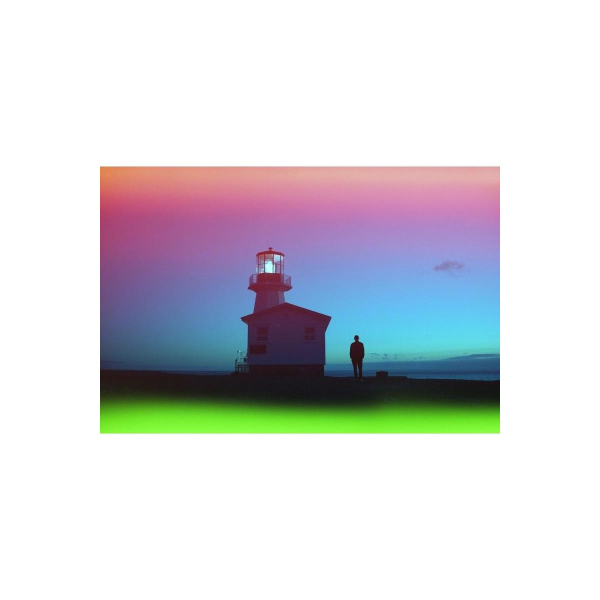 Lighthouse silhouette at dusk with red, blue, and green light-leak effects from Psychedelic Blues 35mm film.