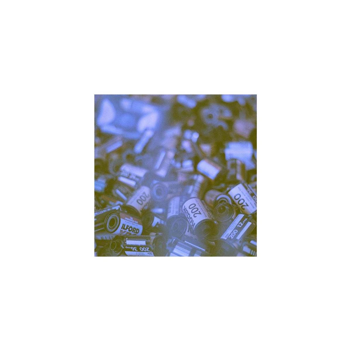 Pile of 35mm film canisters with a blue and yellow color-shifted effect, showcasing various ISO 200 film rolls.