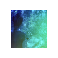 Woman seen from behind with a dreamy blue and green color wash effect on 35mm film.