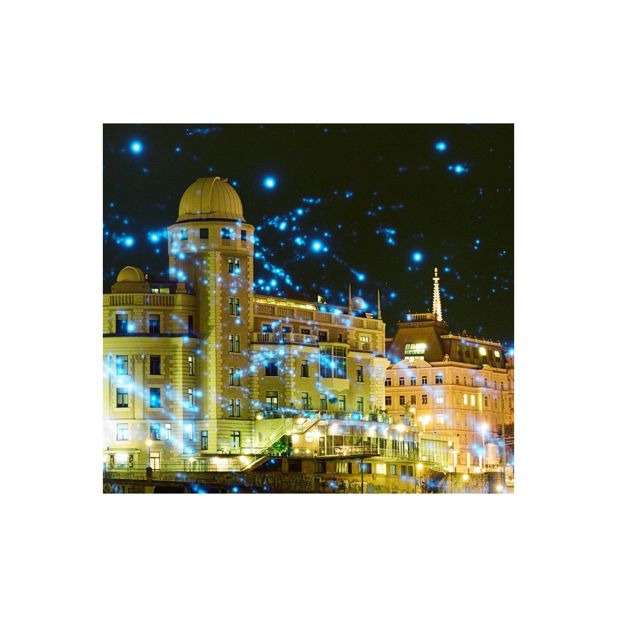 Night cityscape featuring REVOLOG Kosmos 35mm film with glowing blue stardust galaxy effects over illuminated buildings.