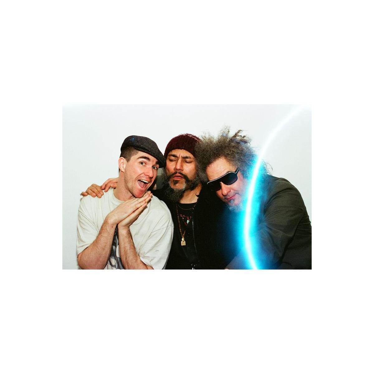 Three people posing together with a glowing blue laser light effect across the frame from Revolog Lazer 35mm film.